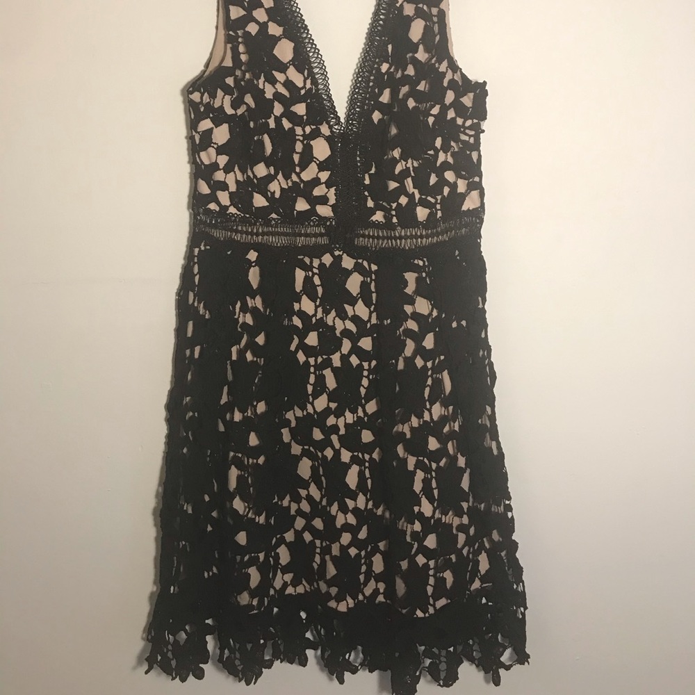 Black lace dress with beige under layer